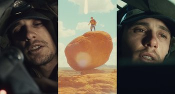 Movie still from “127 Hours” (2010), directed by Danny Boyle – A man standing on top of a brown rock; Wide shot, Low angle