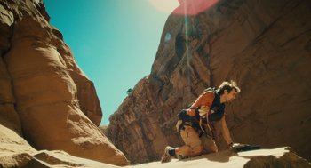 Movie still from “127 Hours” (2010), directed by Danny Boyle – A man climbing up the side of a mountain; Wide shot, Low angle