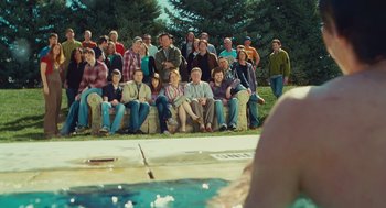 Movie still from “127 Hours” (2010), directed by Danny Boyle – A group of people sitting in front of a swimming pool; Wide shot, Over the shoulder angle