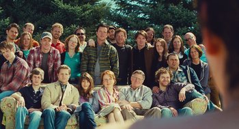 Movie still from “127 Hours” (2010), directed by Danny Boyle – A group of people posing for a picture in front of trees; Wide shot, High angle