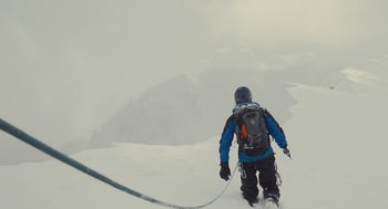 Movie still from “127 Hours” (2010), directed by Danny Boyle – A man in a blue jacket is walking up a hill; Wide shot, Low angle