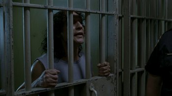 Movie still from “16 Blocks” (2006), directed by Richard Donner – A woman looking out of a jail cell window; Medium shot, High angle