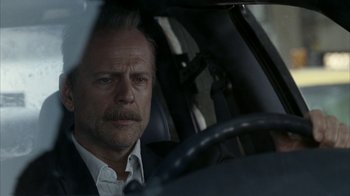 Movie still from “16 Blocks” (2006), directed by Richard Donner – A man sitting in the driver's seat of a car; Close Up shot, Over the shoulder angle