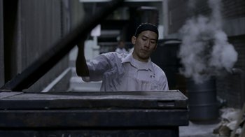 Movie still from “16 Blocks” (2006), directed by Richard Donner – A man standing in front of an object in a room; Medium shot, Low angle