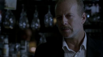 Movie still from “16 Blocks” (2006), directed by Richard Donner – A person wearing a suit and tie; Close Up shot, Over the shoulder angle