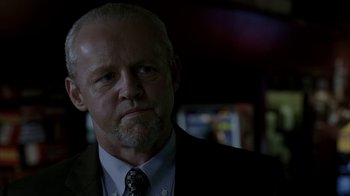 Movie still from “16 Blocks” (2006), directed by Richard Donner – A person wearing a suit and tie; Close Up shot, Low angle