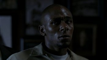 Movie still from “16 Blocks” (2006), directed by Richard Donner – A person wearing a white shirt; Close Up shot, High angle