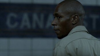 Movie still from “16 Blocks” (2006), directed by Richard Donner – A person wearing a white shirt; Close Up shot, Over the shoulder angle