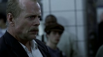 Movie still from “16 Blocks” (2006), directed by Richard Donner – A person wearing a hat; Close Up shot, Over the shoulder angle