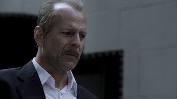 Movie still from “16 Blocks” (2006), directed by Richard Donner – A person wearing a suit and tie; Close Up shot, Low angle
