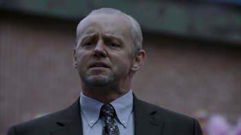Movie still from “16 Blocks” (2006), directed by Richard Donner – An older man in a suit and tie looking to his left; Close Up shot, Low angle