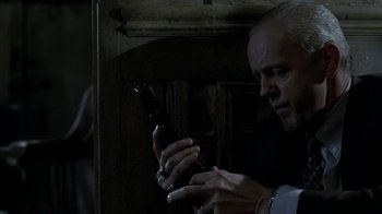 Movie still from “16 Blocks” (2006), directed by Richard Donner – A man looking at his cell phone in a dark room; Close Up shot, Low angle