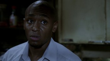 Movie still from “16 Blocks” (2006), directed by Richard Donner – A person wearing a white shirt; Close Up shot, High angle