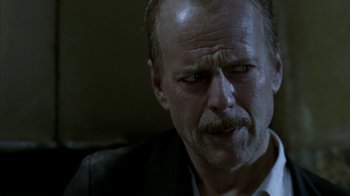 Movie still from “16 Blocks” (2006), directed by Richard Donner – An older man with a beard and a mustache; Close Up shot, Over the shoulder angle