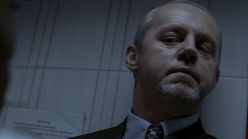 Movie still from “16 Blocks” (2006), directed by Richard Donner – A person wearing a suit and tie; Close Up shot, Low angle