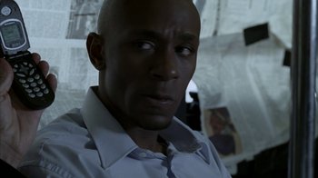 Movie still from “16 Blocks” (2006), directed by Richard Donner – A man with a bald head looking at the camera; Close Up shot, Over the shoulder angle