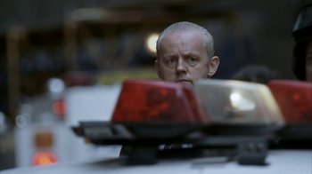 Movie still from “16 Blocks” (2006), directed by Richard Donner – A man with a shaved head looking at the camera; Close Up shot, Low angle