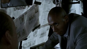 Movie still from “16 Blocks” (2006), directed by Richard Donner – A man in a suit and tie looking into the camera; Close Up shot, Low angle
