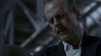 Movie still from “16 Blocks” (2006), directed by Richard Donner – A person wearing a suit and tie; Close Up shot, Low angle