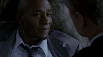 Movie still from “16 Blocks” (2006), directed by Richard Donner – A person wearing a suit and tie; Close Up shot, Over the shoulder angle