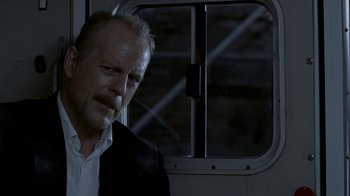 Movie still from “16 Blocks” (2006), directed by Richard Donner – A person wearing a suit and tie; Close Up shot, Low angle