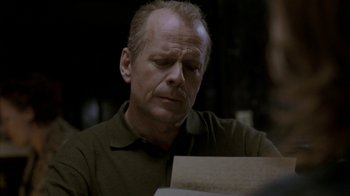 Movie still from “16 Blocks” (2006), directed by Richard Donner – A person sitting at a table; Close Up shot, Over the shoulder angle