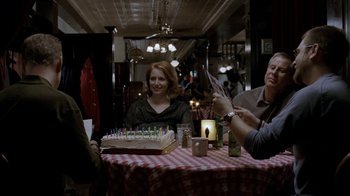 Movie still from “16 Blocks” (2006), directed by Richard Donner – A group of people sitting around a table with a cake; Medium shot, Over the shoulder angle