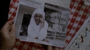 Movie still from “16 Blocks” (2006), directed by Richard Donner – An old photo of a man wearing a white hat; Extreme Close Up shot, High angle