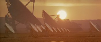 Movie still from “2010: The Year We Make Contact” (1984), directed by Peter Hyams – A line of satellite dishes in front of the setting sun; Extreme Wide shot, Low angle