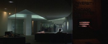 Movie still from “2010: The Year We Make Contact” (1984), directed by Peter Hyams – A man sitting on top of a couch in a living room; Wide shot, Low angle