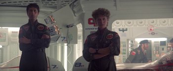 Movie still from “2010: The Year We Make Contact” (1984), directed by Peter Hyams – A woman in a space suit standing in front of a building; Medium shot, Low angle