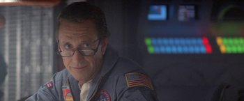 Movie still from “2010: The Year We Make Contact” (1984), directed by Peter Hyams – A person wearing glasses and a uniform; Close Up shot, Low angle