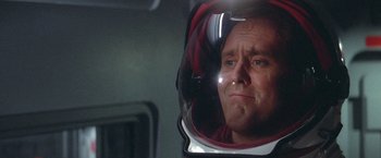 Movie still from “2010: The Year We Make Contact” (1984), directed by Peter Hyams – A person wearing a helmet in a mirror; Close Up shot, Low angle