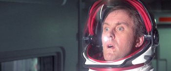 Movie still from “2010: The Year We Make Contact” (1984), directed by Peter Hyams – A man in a space suit looking surprised; Close Up shot, Low angle