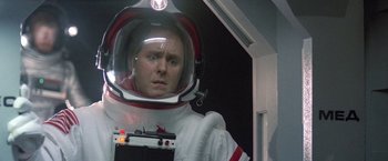 Movie still from “2010: The Year We Make Contact” (1984), directed by Peter Hyams – A man in a spacesuit is holding a camera; Close Up shot, Low angle