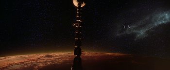 Movie still from “2010: The Year We Make Contact” (1984), directed by Peter Hyams – A tower with a moon in the sky above it; Extreme Wide shot, Low angle