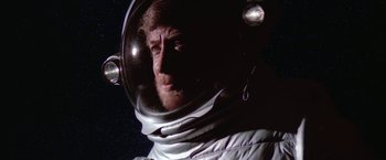 Movie still from “2010: The Year We Make Contact” (1984), directed by Peter Hyams – A man in a spacesuit is looking into the distance; Close Up shot, Low angle