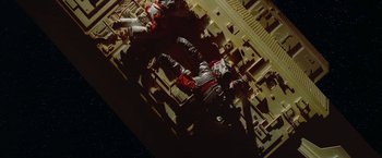 Movie still from “2010: The Year We Make Contact” (1984), directed by Peter Hyams – An overhead view of two astronauts in a space station; Extreme Wide shot, Overhead angle