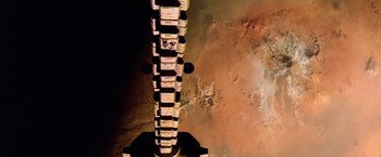 Movie still from “2010: The Year We Make Contact” (1984), directed by Peter Hyams – An aerial view of a space station in the middle of the day; Extreme Wide shot, Low angle