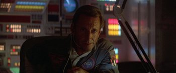 Movie still from “2010: The Year We Make Contact” (1984), directed by Peter Hyams – A man in a space suit is listening to music; Close Up shot, Low angle
