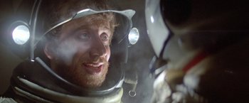 Movie still from “2010: The Year We Make Contact” (1984), directed by Peter Hyams – A person wearing a space suit; Close Up shot, Over the shoulder angle