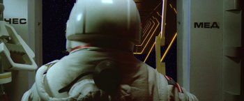 Movie still from “2010: The Year We Make Contact” (1984), directed by Peter Hyams – A person in a spacesuit is looking up at the sky; Medium shot, Low angle