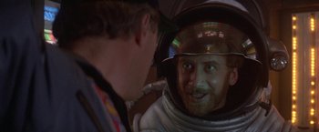 Movie still from “2010: The Year We Make Contact” (1984), directed by Peter Hyams – A man in a spacesuit looking at himself in a mirror; Close Up shot, Over the shoulder angle