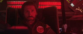 Movie still from “2010: The Year We Make Contact” (1984), directed by Peter Hyams – A man sitting in a chair in front of a red screen; Close Up shot, Over the shoulder angle