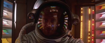 A man in a spacesuit is looking at the camera