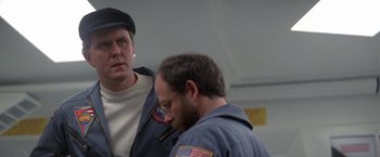 Movie still from “2010: The Year We Make Contact” (1984), directed by Peter Hyams – Two men standing next to each other in a room; Close Up shot, Over the shoulder angle