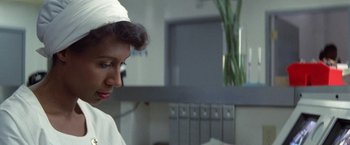 Movie still from “2010: The Year We Make Contact” (1984), directed by Peter Hyams – A person wearing a white hat; Close Up shot, Over the shoulder angle