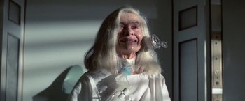 Movie still from “2010: The Year We Make Contact” (1984), directed by Peter Hyams – An old woman with long white hair is holding a wine glass; Close Up shot, High angle
