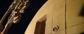 Movie still from “2010: The Year We Make Contact” (1984), directed by Peter Hyams – View of the side of a spaceship; Extreme Wide shot, Low angle