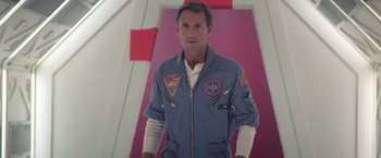 Movie still from “2010: The Year We Make Contact” (1984), directed by Peter Hyams – A man in a space suit standing in front of a pink wall; Medium shot, Low angle